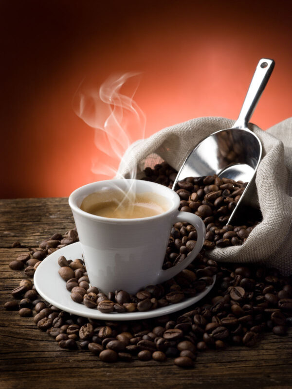 Cup of coffee with steam and coffee beans Cup of coffee with steam and coffee beans