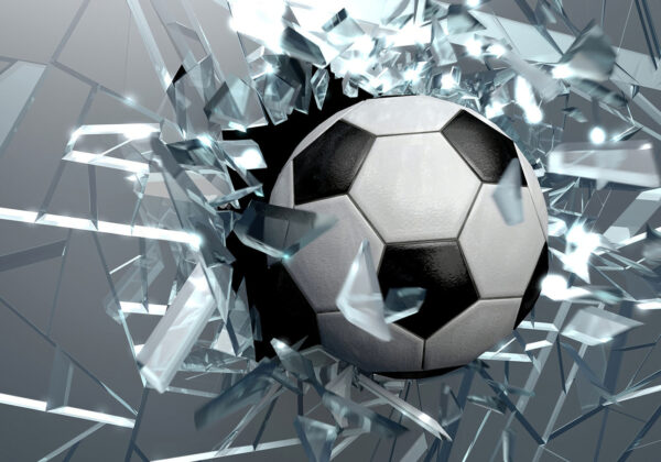 Football ball breaking through glass Football ball breaking through glass