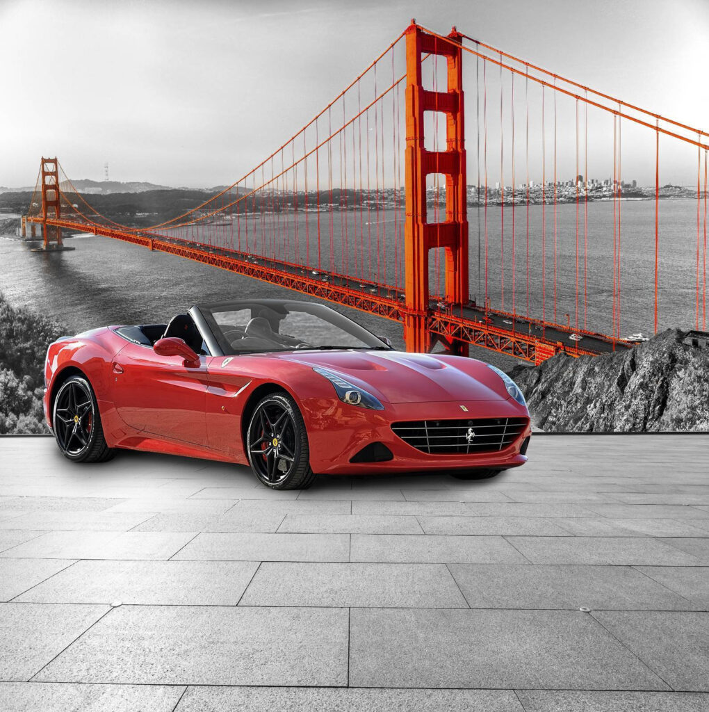 Red sports car on a road with a bridge in the background Red sports car on a road with a bridge in the background
