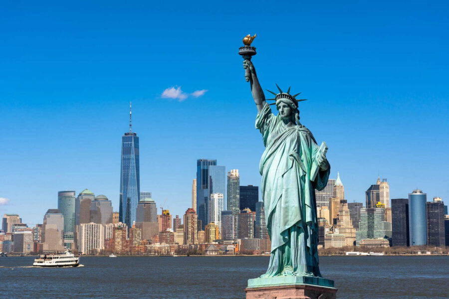 Statue of liberty with a city in the background