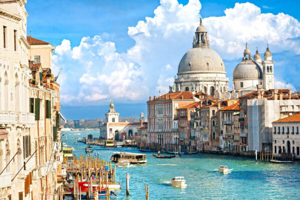 Water way with boats and buildings in the background Water way with boats and buildings in the background