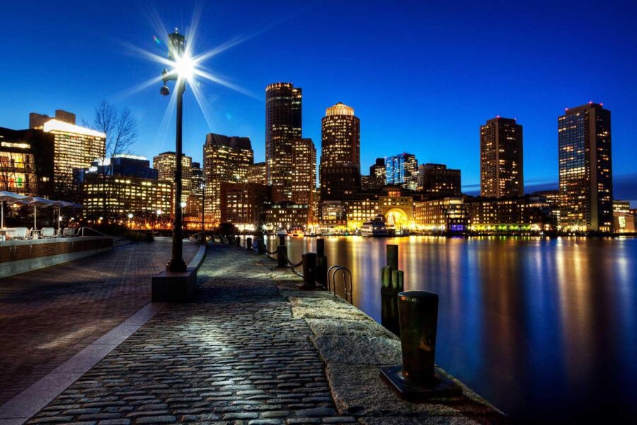 City skyline at night with a body of water