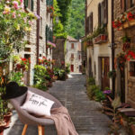 Wall murals Narrow street with flowers and plants on the side