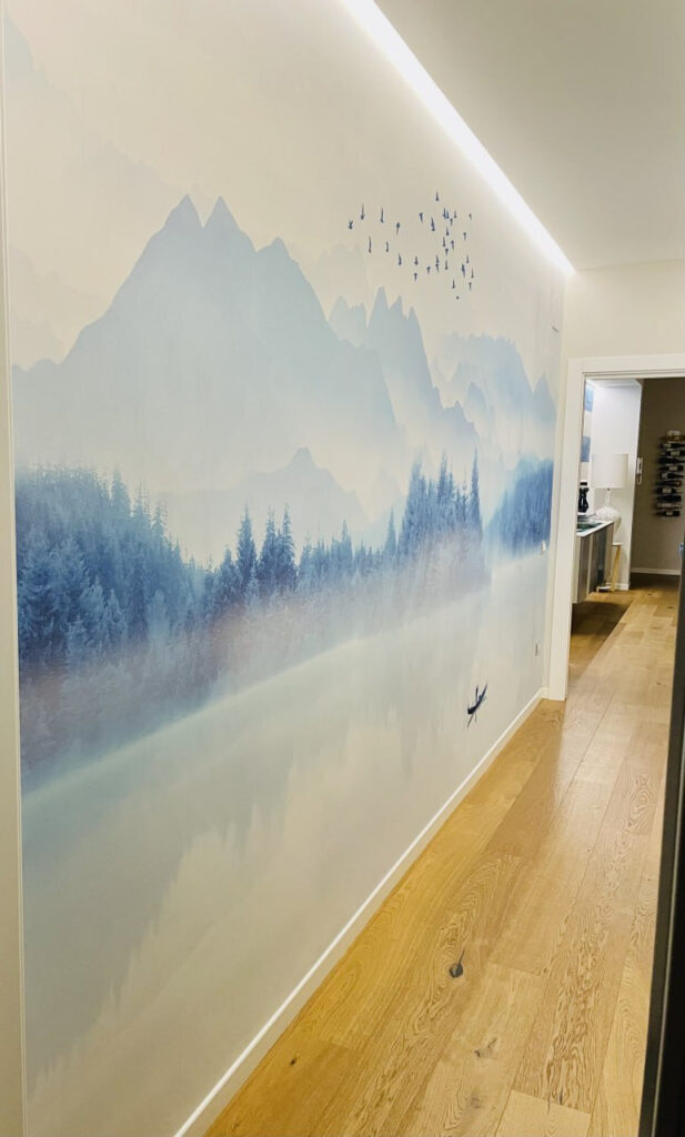 Person in a boat on a lake with birds flying in the sky