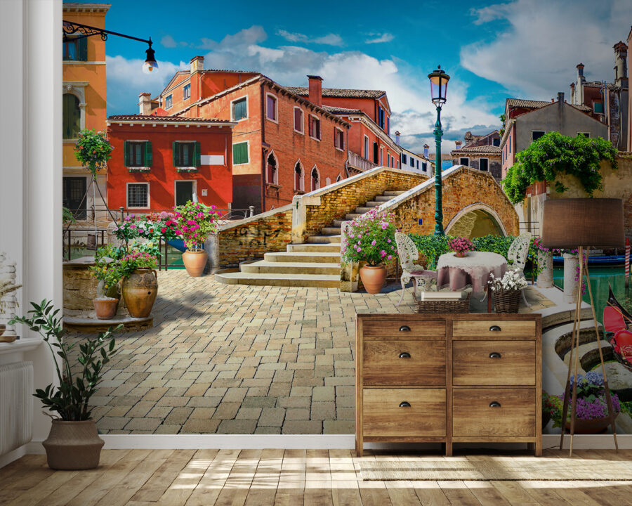 Patio with a table and chairs and a fountain in front of a building