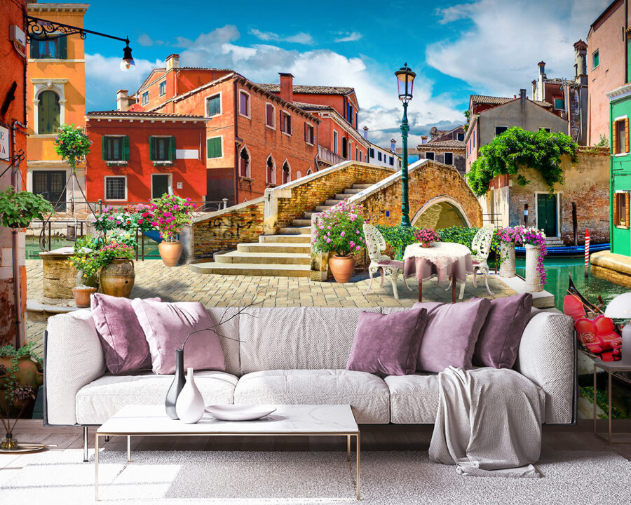 Patio with a table and chairs and a fountain in front of a building