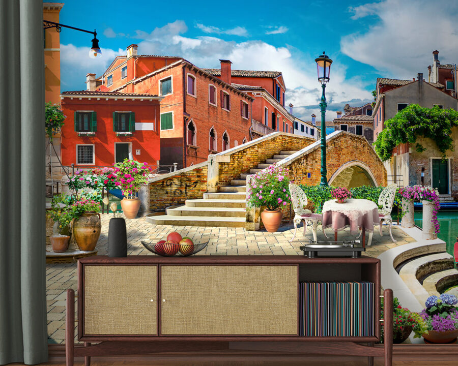 Patio with a table and chairs and a fountain in front of a building