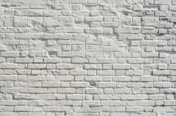 White brick wall with black spots White brick wall with black spots