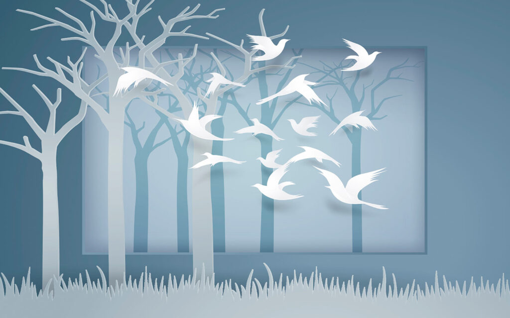 Paper cut out of birds flying in the air Paper cut out of birds flying in the air