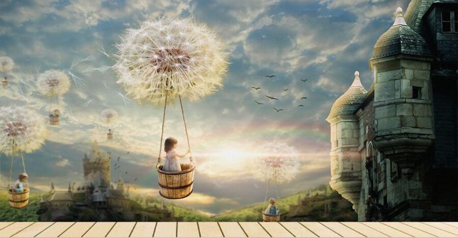 Girl in a basket on a swing with a dandelion in the sky