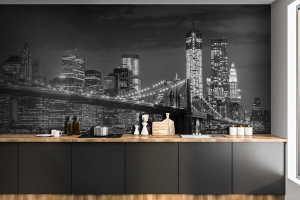 Bridge over water with city skyline at night