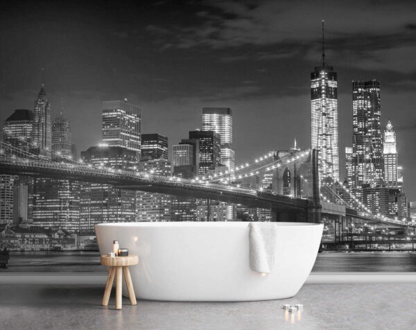 Bridge over water with city skyline at night