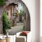Wall mural Stone archway with plants and stairs
