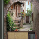 Stone archway with plants and stairs Wall mural Stone archway with plants and stairs