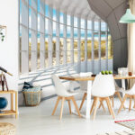 Wall murals Large room with windows and a beach view