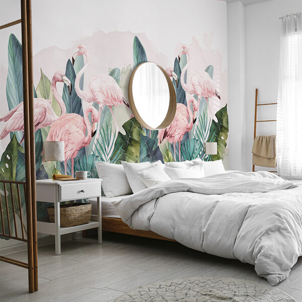 A room with a bed and a wall mural of flamingos