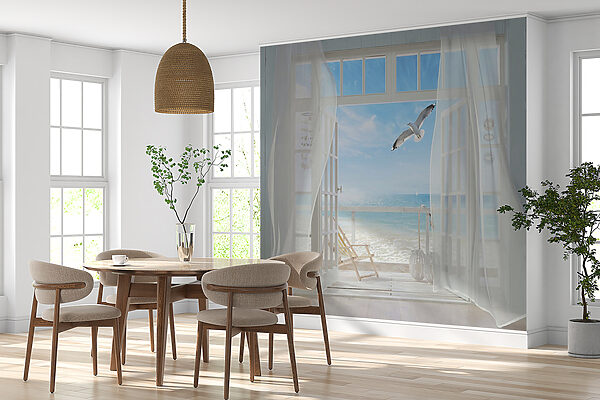 View of a beach from a room with a bird flying over it View of a beach from a room with a bird flying over it