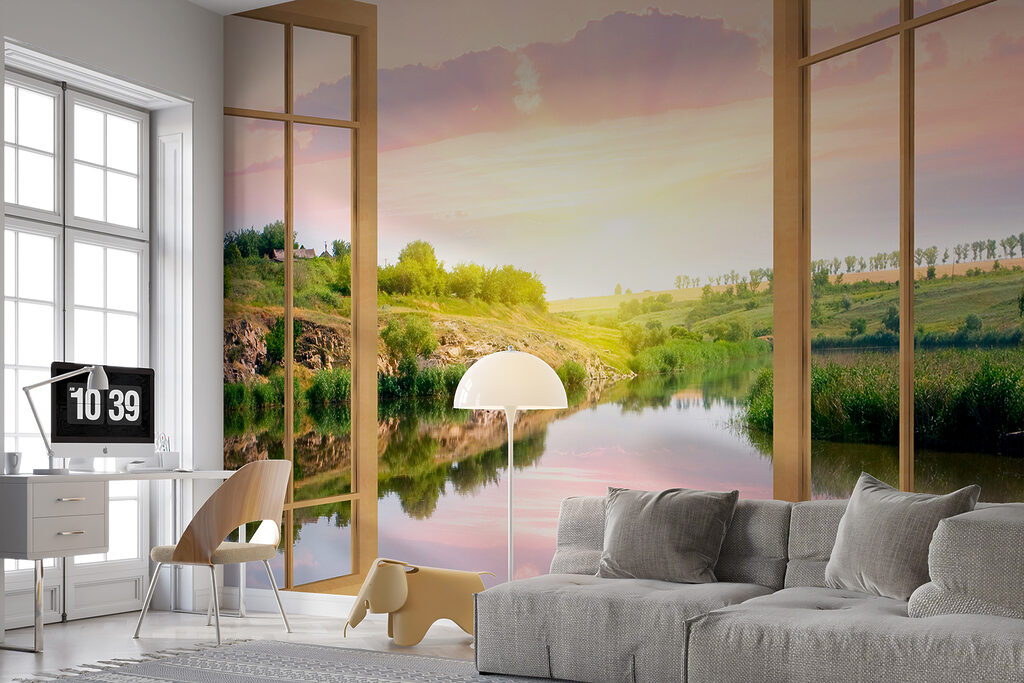 Window with a view of a river and a grassy hill