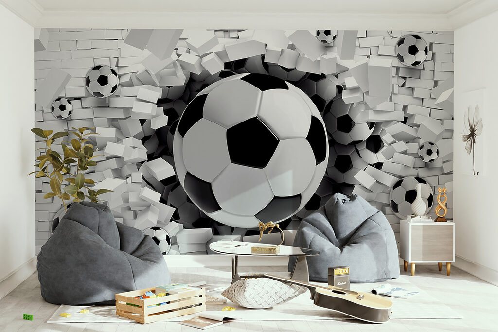 Football ball breaking through a brick wall