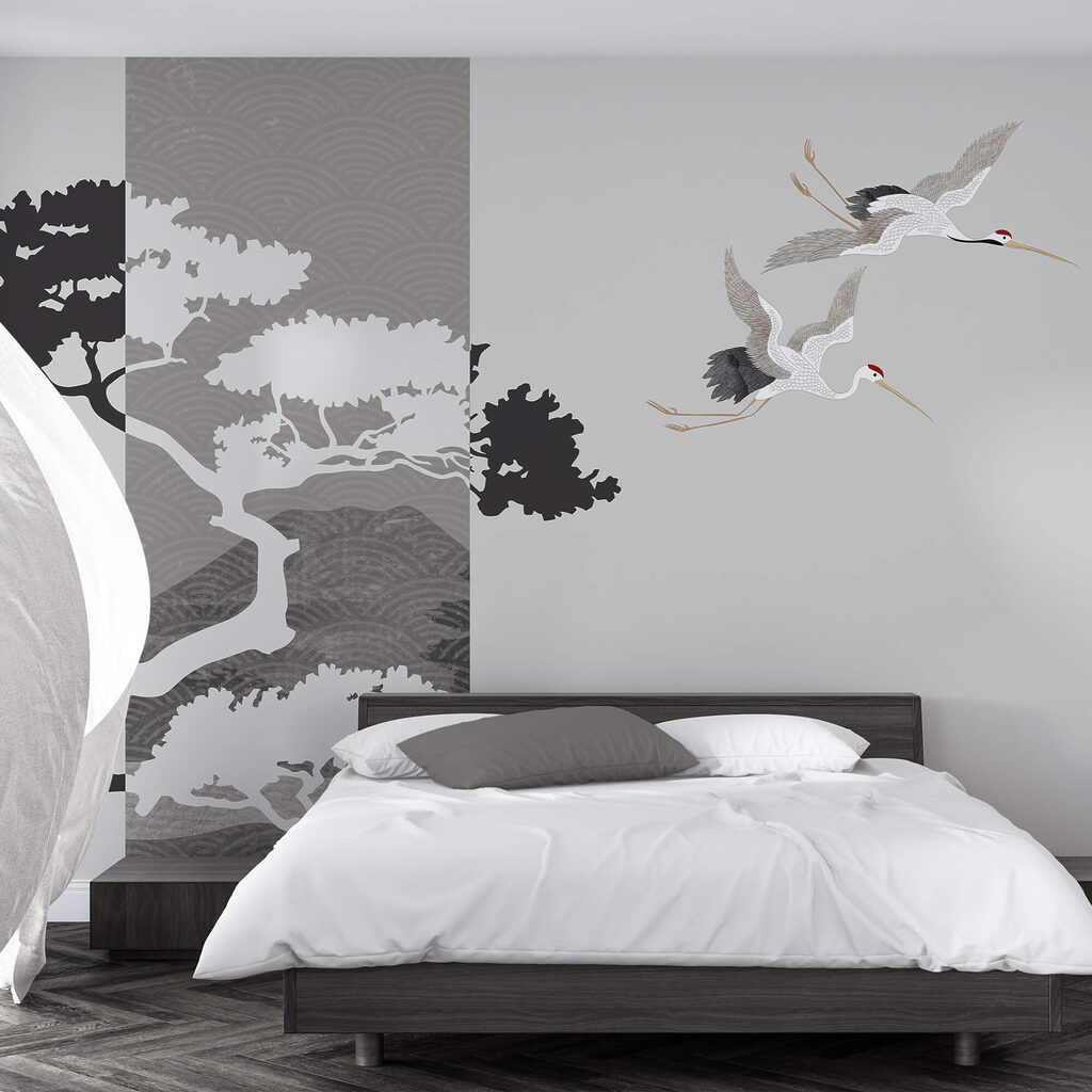 Couple of cranes flying next to a tree Couple of cranes flying next to a tree