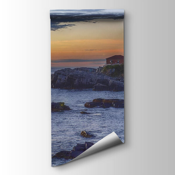 Lighthouse on a rocky shore with a cruise ship in the background