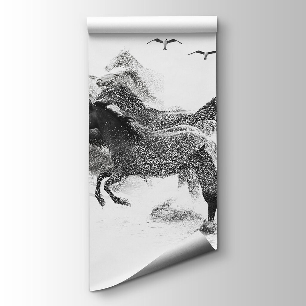 A group of horses running through water A group of horses running through water