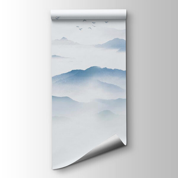 Birds flying over a foggy mountain range