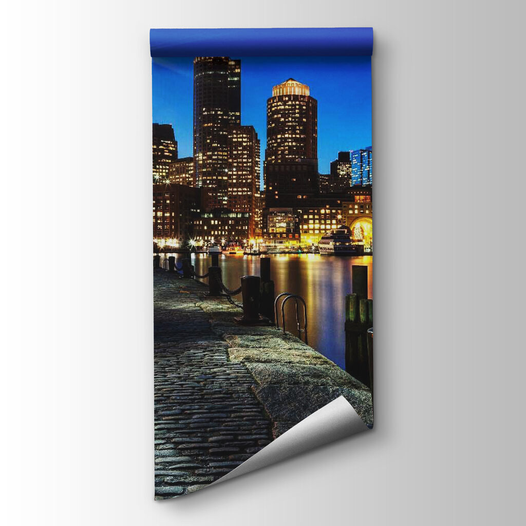 City skyline at night with a body of water