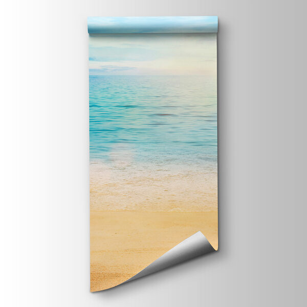 Sandy beach with blue water and a blue sky