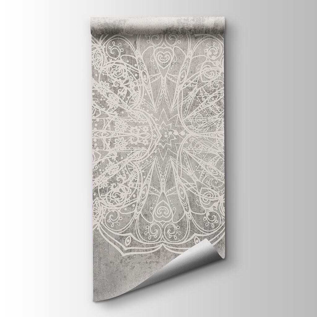 White ornate design on a grey surface